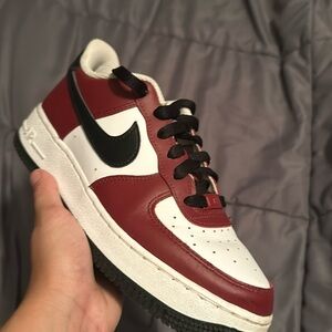 Red and white Air Forces minor crease on the right shoe